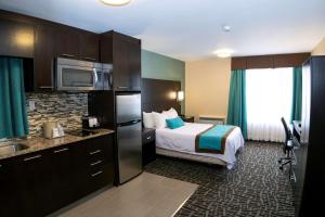 a hotel room with a bed and a kitchen at Best Western Plus Barrie in Barrie +28 photos