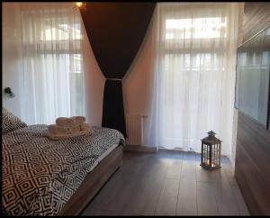 a bedroom with a bed with two towels on it at Family Apartment Golden Tulip in Międzyzdroje +18 photos
