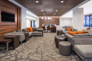a waiting room with couches and a table and chairs at Wingate by Wyndham Page Lake Powell in Page