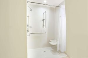 a white bathroom with a shower and a toilet at Wingate by Wyndham Page Lake Powell in Page