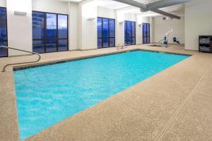 a large swimming pool with blue water in a building at Wingate by Wyndham Page Lake Powell in Page