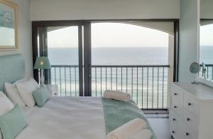 a bedroom with a bed with a view of the ocean at 1104 The Bermudas - by Stay in Umhlanga in Durban