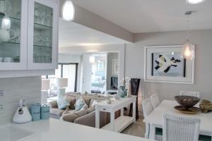 a kitchen and living room with a couch and a table at 1104 The Bermudas - by Stay in Umhlanga in Durban