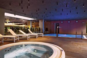 a large room with a hot tub in a building at Family Apartment Golden Tulip in Międzyzdroje