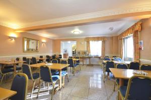 a dining room with wooden tables and chairs at White House Hotel in London