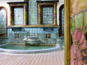 a fountain in front of a building with windows at Iwamotoro in Fujisawa