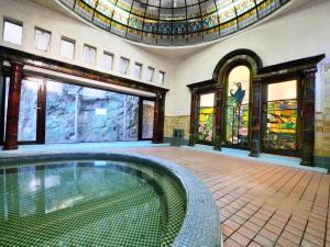 a swimming pool in a building with stained glass windows at Iwamotoro in Fujisawa