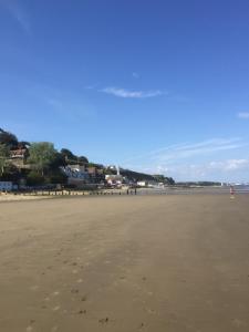 a sandy beach with footprints in the sand at Tides Reach in Shanklin