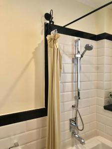 a shower with a shower curtain in a bathroom at Phasouk Vien Chantra Hotel in Vientiane