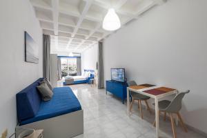 a living room with a blue couch and a table at MV83 new marina in Rhodes Town