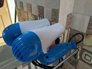a blue and white blow dryer in a bathroom at Rivinu Holiday Resort in Ella