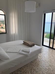 a bedroom with a bed with a view of the ocean at Cloudberry in Kalyves