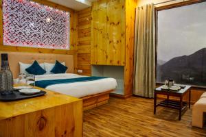 a bedroom with a bed and a large window at Jade Vine Resort in Shogi