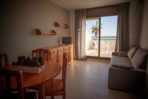 a living room with a table and a room with a view at Apartamentos Florida II in Peñíscola