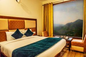 a hotel room with a bed and a large window at Jade Vine Resort in Shogi