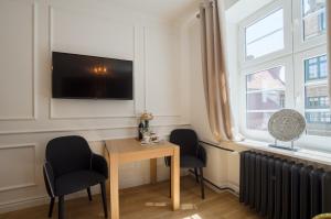 Televízia a/alebo spoločenská miestnosť v ubytovaní Basilica Apartment Mariacka Gdansk