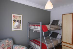 a bedroom with two bunk beds and a couch at Guelbenzu by clabao in Pamplona +2 photos