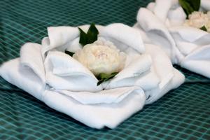 a white flower sitting on top of a green table at Hotel Tourist in Rivne