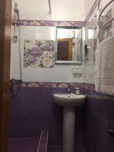 a bathroom with a sink and a mirror at Zolotoi Bereg 31 in Odesa