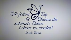 a sign for a classroom with a butterfly on a wall at Pension Weinig in Gersfeld