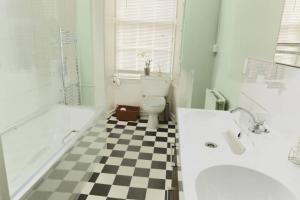 a bathroom with a black and white checkered floor at ALTIDO Heart of Edinburgh Gem in Edinburgh