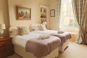 a bedroom with two beds and a window at ALTIDO Heart of Edinburgh Gem in Edinburgh