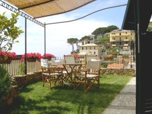 a patio with a table and chairs on the grass at Casa Lorenza in Riomaggiore