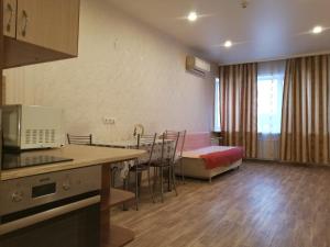 a room with a kitchen and a living room with a bed at Apartment on Karla Libknekhta in Irkutsk