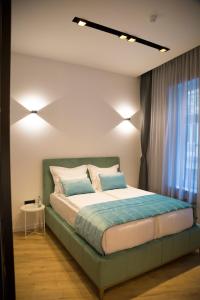 Premium Apartments tesisinde bir odada yatak veya yataklar