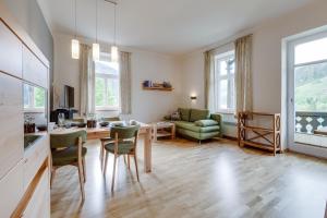 a large living room with a table and chairs at Herrenhaus am Erlaufsee - DorfResort Mitterbach in Mariazell