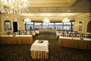 a banquet hall with tables and chairs and chandeliers at Molly Pitcher Inn in Red Bank