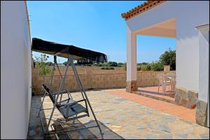 a ladder on the side of a house with a patio at Chalet Ruperto in Conil de la Frontera