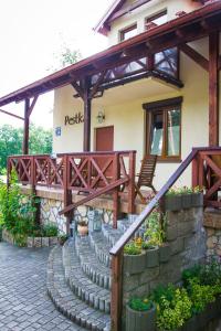 a house with a staircase in front of it at Pestka in Jastarnia