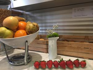 a bowl of fruit on a counter with strawberries at Hotel Sant Roc in Solsona