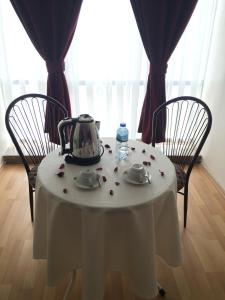 a table with a tea kettle on top of it at Ayvazali Hotel in Bergama