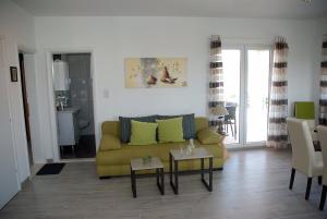 a living room with a yellow couch and a table at Villa Isabella in Sevid
