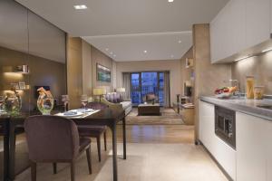 a kitchen and living room with a table and chairs at Somerset Grandview Shenzhen in Shenzhen