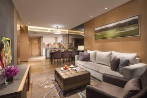 a living room with a couch and a table at Somerset Grandview Shenzhen in Shenzhen