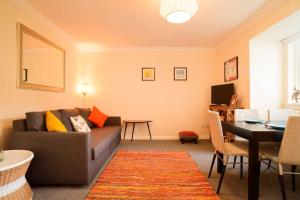 a living room with a couch and a table at ALTIDO Lovely Apartment for 4 with Free Parking in Edinburgh