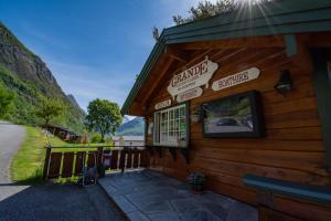 a building with signs on the side of it at Grande Hytteutleige og Camping in Geiranger