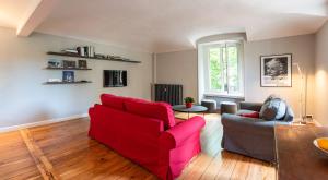 a living room with a red couch and a table at A due passi da tutto in Turin