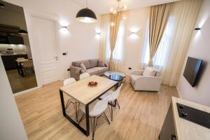 a living room with a table and chairs and a couch at Premium Apartments in Sarajevo
