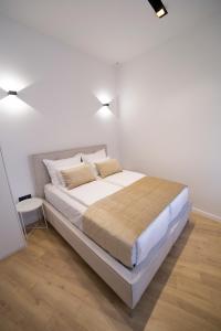 Premium Apartments tesisinde bir odada yatak veya yataklar