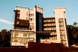 a building with a sign in front of it at Copper Folia in Kozhikode