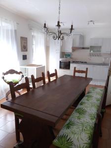 a dining room with a wooden table and chairs at Mia Casa in Verrucola in Fivizzano