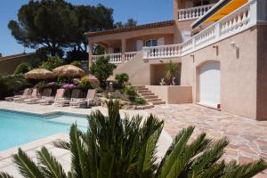 a villa with a swimming pool and a house at Villa Chantilly in Saint-Raphaël