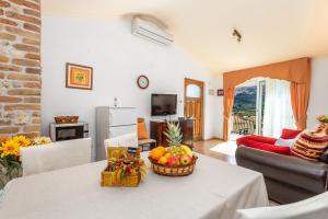 a living room with a table with a basket of fruit at Apartments Patricia in Baška
