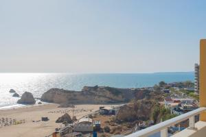 a view of the beach from the balcony of a condo at Hotel Avenida Praia in Portimão