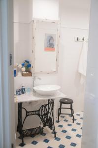 een badkamer met een wastafel en een kruk bij Sancha de Lara in Málaga