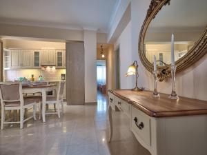 a kitchen and dining room with a mirror on the wall at Giovanna's Lux Apartment in Zakynthos
